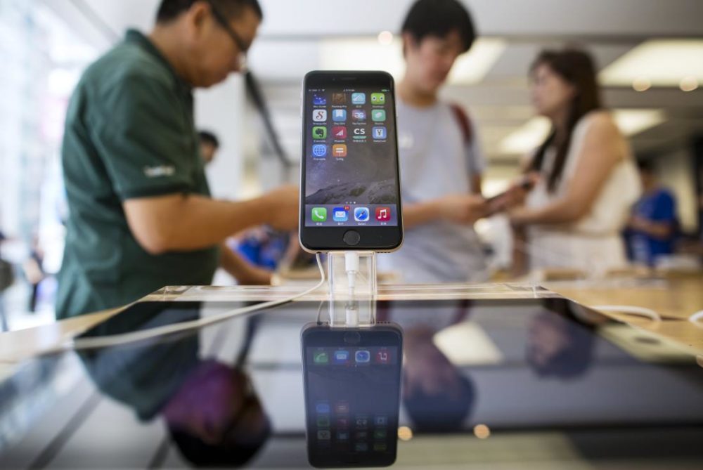 An Apple Inc. iPhone 6 stands on display at the company's Causeway Bay store during the sales launch of the iPhone 6 and iPhone 6 Plus in Hong Kong, China, on Friday, Sept. 19, 2014. Apple stores attracted long lines of shoppers for the debut of the latest iPhones, indicating healthy demand for the bigger-screen smartphones. Photographer: Jerome Favre/Bloomberg via Getty Images